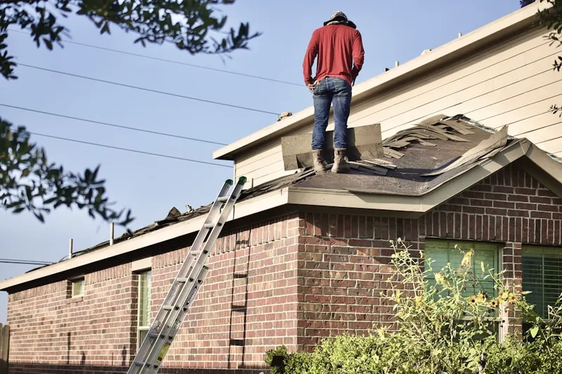 Professional roofer working on a residential roof in Faxon Court